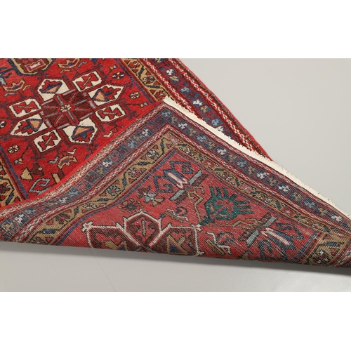 1746 - A HERIZ RUNNER, NORTH WEST PERSIA, 2ND HALF 20TH CENTURY. the brick red field with a column of styli... 