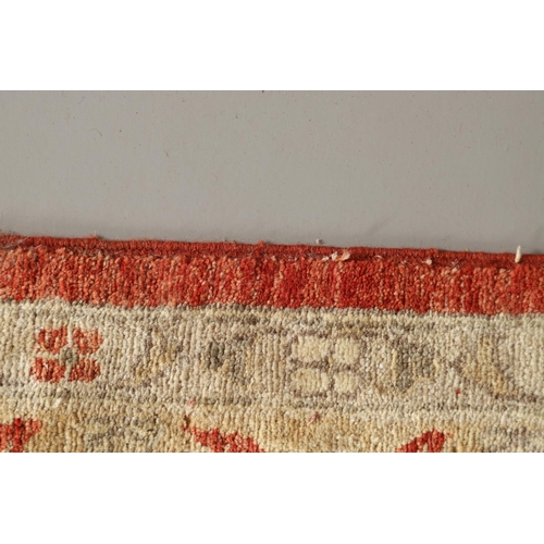 1747 - A MODERN AFGHAN ZIEGLAR DESIGN CARPET. the terracotta field with an all over design of palmettes and... 