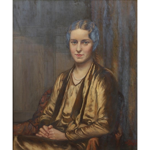 624 - ARTHUR GEORGE WALKER, RA (1861-1939). PORTRAIT OF A LADY. Seated half length, wearing a brown/gold d... 