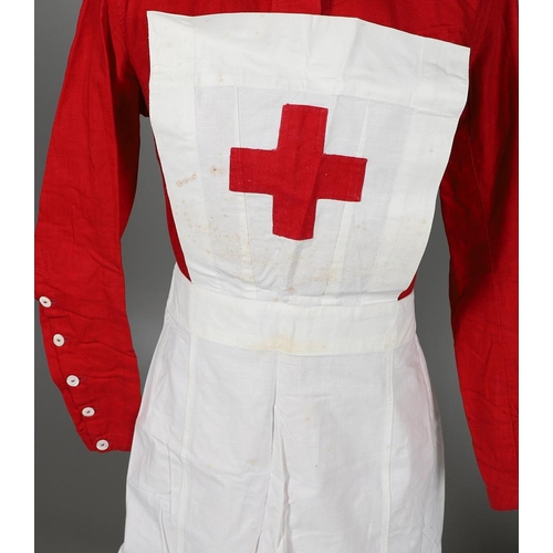 677 - VINTAGE NURSES UNIFORMS & RED CROSS APRONS. A qty of Nurses Uniforms to include a blue Chambray cott... 