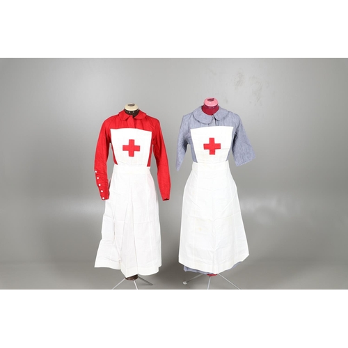 677 - VINTAGE NURSES UNIFORMS & RED CROSS APRONS. A qty of Nurses Uniforms to include a blue Chambray cott... 