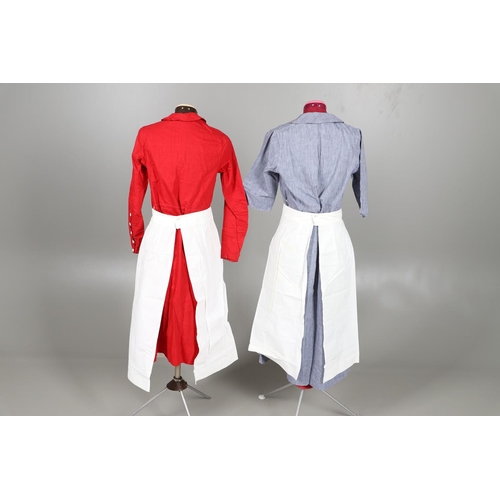 677 - VINTAGE NURSES UNIFORMS & RED CROSS APRONS. A qty of Nurses Uniforms to include a blue Chambray cott... 