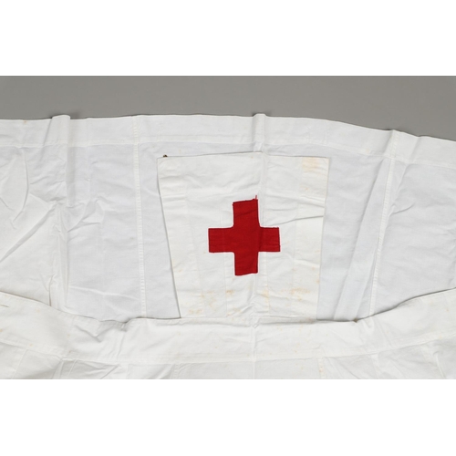 677 - VINTAGE NURSES UNIFORMS & RED CROSS APRONS. A qty of Nurses Uniforms to include a blue Chambray cott... 