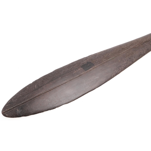 725 - LARGE TRIBAL HARDWOOD PADDLE. Possibly South Sea Islands, a large hardwood tribal paddle with a tape... 