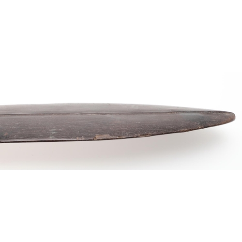 725 - LARGE TRIBAL HARDWOOD PADDLE. Possibly South Sea Islands, a large hardwood tribal paddle with a tape... 