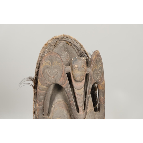 753 - LARGE AFRICAN TRIBAL MASK. An unsually large tribal mask, carved with various human and animal masks... 