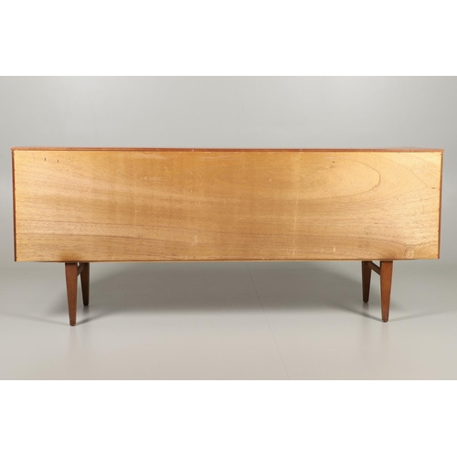 773 - MID CENTURY TEAK SIDEBOARD - BEAUTILITY. A large teak sideboard with a curved front, with three cent... 