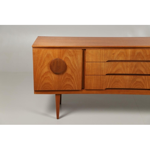 773 - MID CENTURY TEAK SIDEBOARD - BEAUTILITY. A large teak sideboard with a curved front, with three cent... 