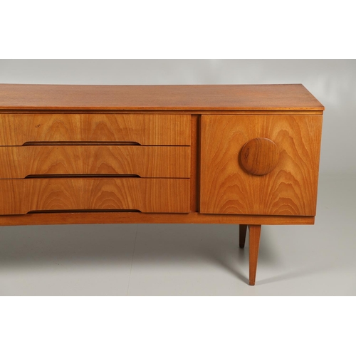 773 - MID CENTURY TEAK SIDEBOARD - BEAUTILITY. A large teak sideboard with a curved front, with three cent... 