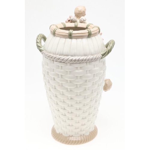 784 - LARGE AMPHORA VASE. A large vase in the form of a basket weave basket, with cherubs and flowers in r... 