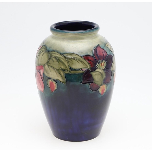 794 - WILLIAM MOORCROFT VASE - CLEMATIS. A large William Moorcroft vase in the Clematis design on a green ... 