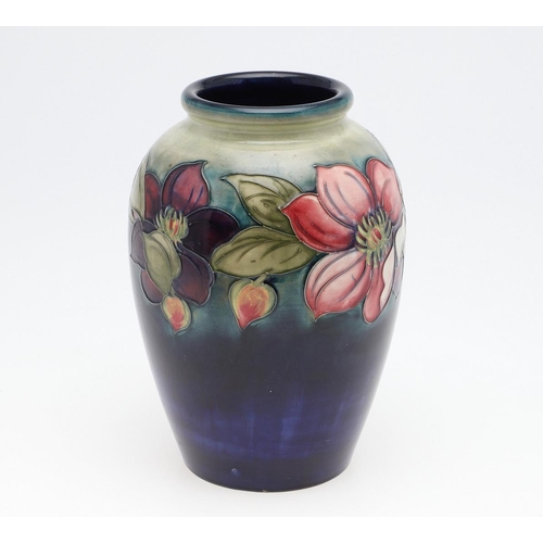 794 - WILLIAM MOORCROFT VASE - CLEMATIS. A large William Moorcroft vase in the Clematis design on a green ... 