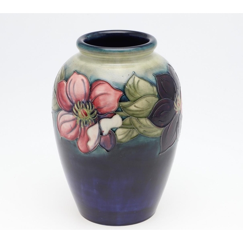 794 - WILLIAM MOORCROFT VASE - CLEMATIS. A large William Moorcroft vase in the Clematis design on a green ... 