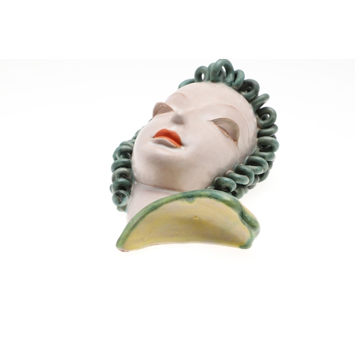 801 - GOLDSCHEIDER ART DECO WALL MASK. An Art Deco 1930's terracotta wall mask, painted with green ringlet... 