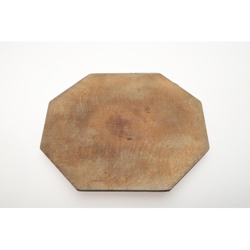 803 - ROBERT THOMPSON OF KILBURN - MOUSEMAN BREAD BOARD. An oak bread board of canted rectangular shape, w... 