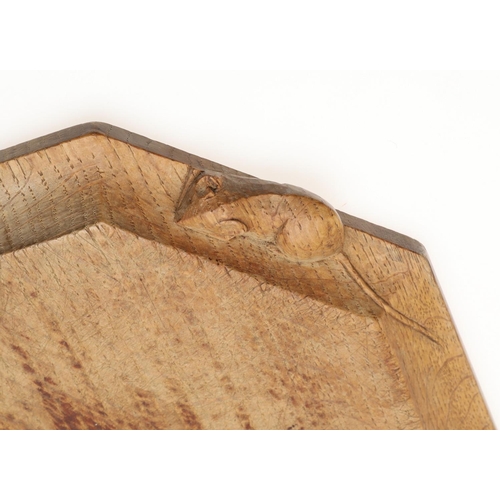 803 - ROBERT THOMPSON OF KILBURN - MOUSEMAN BREAD BOARD. An oak bread board of canted rectangular shape, w... 