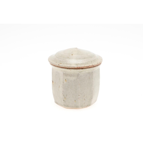 817 - RICHARD BATTERHAM (1936-2021) - LIDDED JAR. (d) A stoneware cut sided jar with celadon glaze and dom... 