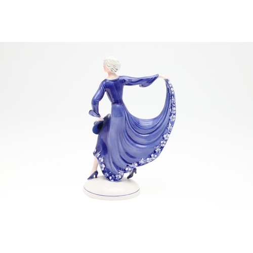 822 - KATZHUTTE GERMAN ART DECO FIGURE OF A LADY. A 1930's porcelain figure of a lady in a blue dress, hol... 