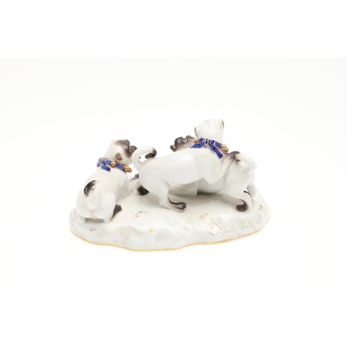 837 - MEISSEN PORCELAIN PUG GROUP. A late 19thc porcelain group of three Pug Dogs at play, each with blue ... 