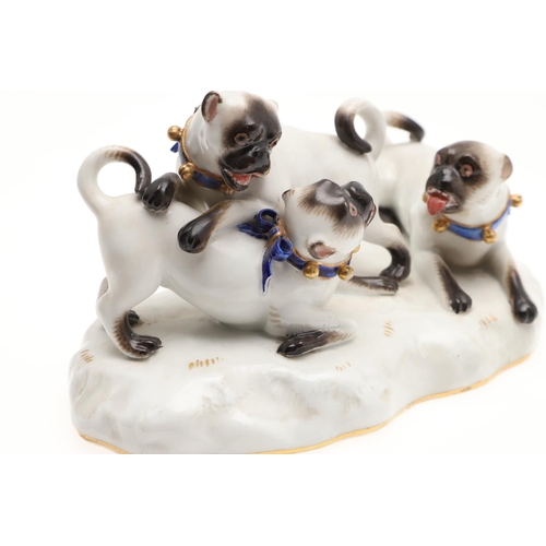 837 - MEISSEN PORCELAIN PUG GROUP. A late 19thc porcelain group of three Pug Dogs at play, each with blue ... 