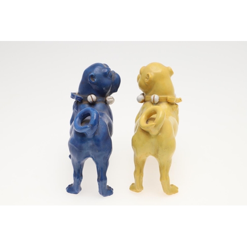 839 - PORCELAIN MODELS OF PUG DOGS. Including a pair of yellow glazed porcelain models of standing Pug dog... 