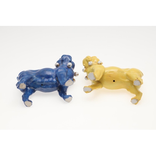 839 - PORCELAIN MODELS OF PUG DOGS. Including a pair of yellow glazed porcelain models of standing Pug dog... 