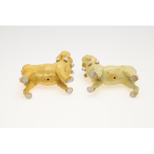 839 - PORCELAIN MODELS OF PUG DOGS. Including a pair of yellow glazed porcelain models of standing Pug dog... 