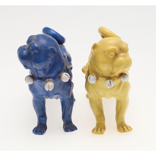 839 - PORCELAIN MODELS OF PUG DOGS. Including a pair of yellow glazed porcelain models of standing Pug dog... 