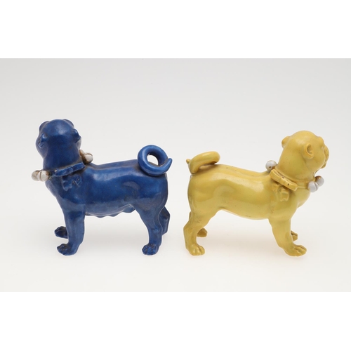 839 - PORCELAIN MODELS OF PUG DOGS. Including a pair of yellow glazed porcelain models of standing Pug dog... 