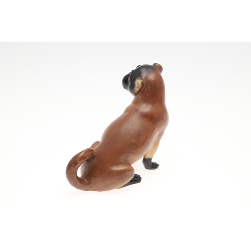 843 - PORCELAIN MODELS OF PUG DOGS. Including a Meissen style porcelain model of a seated Pug (17.5cms hig... 