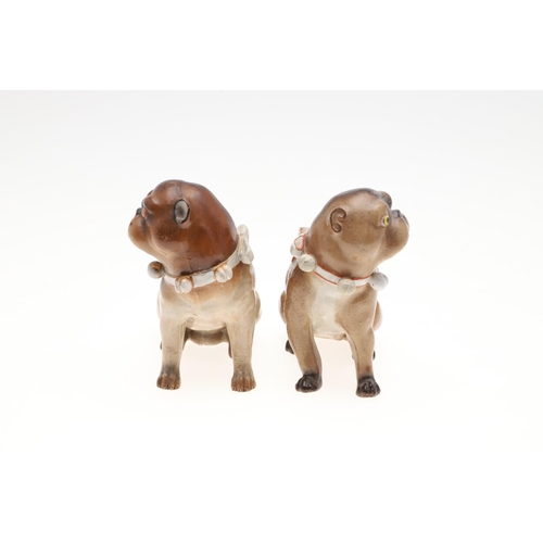 843 - PORCELAIN MODELS OF PUG DOGS. Including a Meissen style porcelain model of a seated Pug (17.5cms hig... 