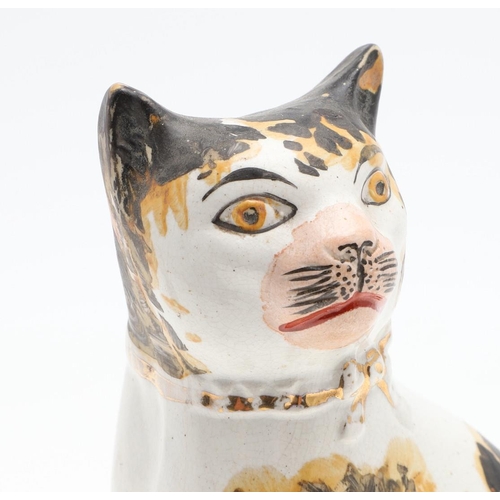 851 - A PAIR OF 19TH CENTURY STAFFORDSHIRE POTTERY CATS. A pair of 19thc Staffordshire pottery figures of ... 