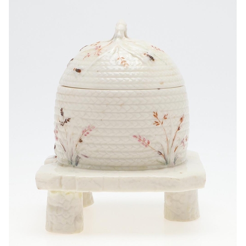 852 - BELLEEK FIRST PERIOD HONEY POT. A lidded honey pot in the form of a wicker bee skep, painted with be... 