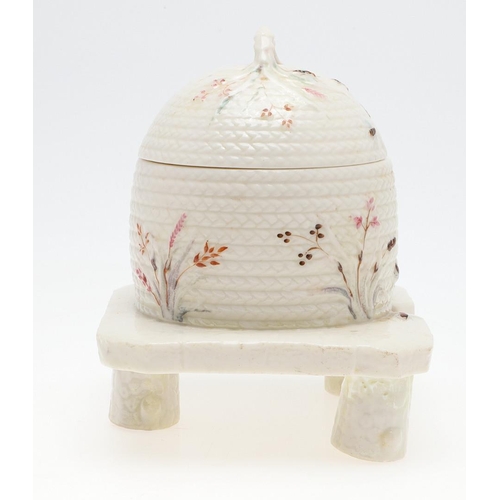 852 - BELLEEK FIRST PERIOD HONEY POT. A lidded honey pot in the form of a wicker bee skep, painted with be... 