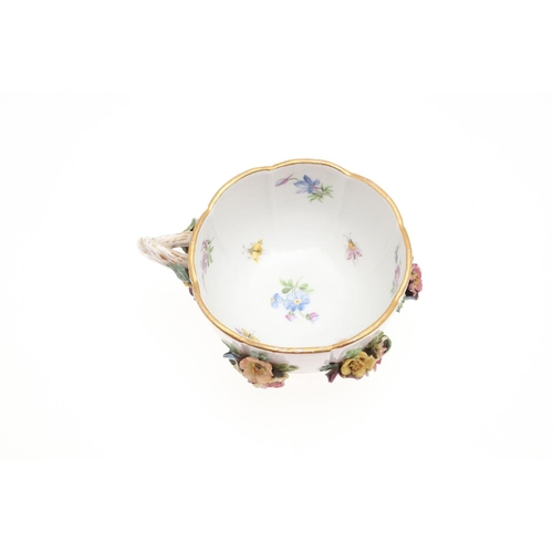 853 - MEISSEN CUP & SAUCER, & SIMILAR CUP & SAUCER. A Meissen cup and saucer, painted with a variety of fl... 