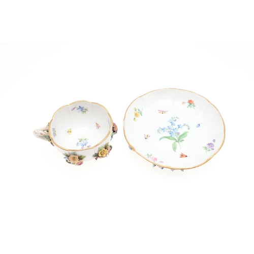 853 - MEISSEN CUP & SAUCER, & SIMILAR CUP & SAUCER. A Meissen cup and saucer, painted with a variety of fl... 