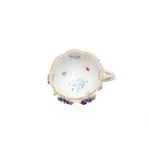 853 - MEISSEN CUP & SAUCER, & SIMILAR CUP & SAUCER. A Meissen cup and saucer, painted with a variety of fl... 