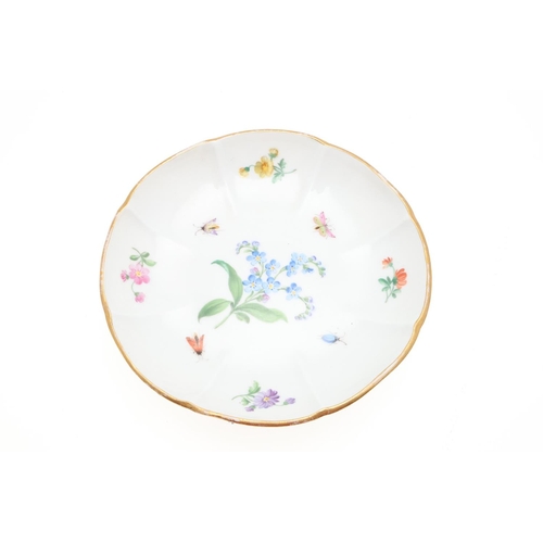 853 - MEISSEN CUP & SAUCER, & SIMILAR CUP & SAUCER. A Meissen cup and saucer, painted with a variety of fl... 