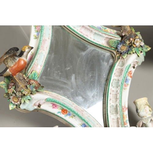 865 - PAIR OF CONTINENTAL PORCELAIN MIRRORS. Probably German, the shaped mirrors each mounted with cherub ... 