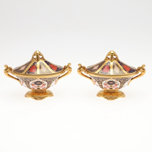 870 - PAIR OF ROYAL CROWN DERBY IMARI LIDDED PEDESTAL BOWLS. A pair of oval shaped bowls, painted with pan... 