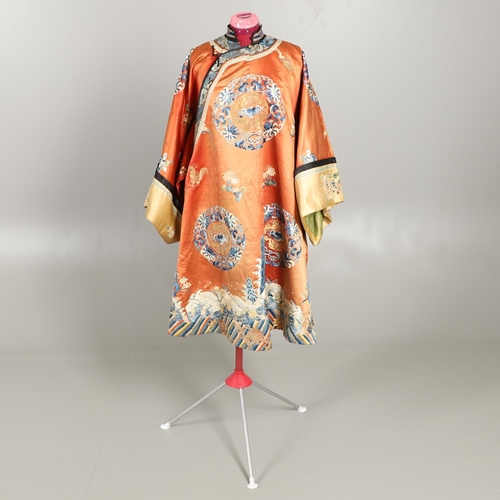 950 - EARLY 20TH CENTURY CHINESE EMBROIDERED SILK ROBE. A 3/4 length red silk robe heavily embroidered wit... 