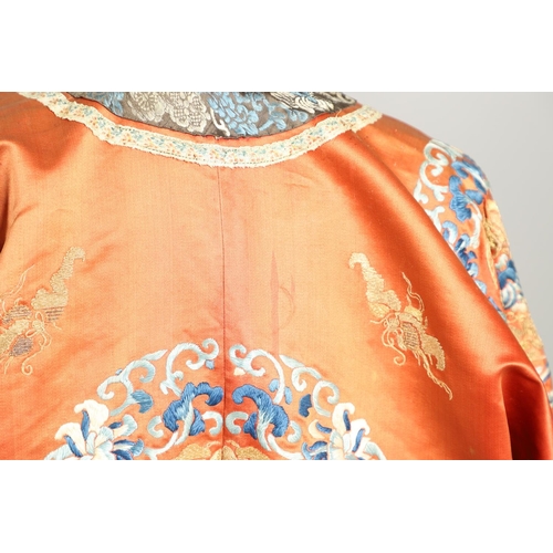 950 - EARLY 20TH CENTURY CHINESE EMBROIDERED SILK ROBE. A 3/4 length red silk robe heavily embroidered wit... 