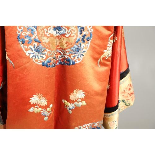 950 - EARLY 20TH CENTURY CHINESE EMBROIDERED SILK ROBE. A 3/4 length red silk robe heavily embroidered wit... 