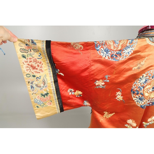 950 - EARLY 20TH CENTURY CHINESE EMBROIDERED SILK ROBE. A 3/4 length red silk robe heavily embroidered wit... 