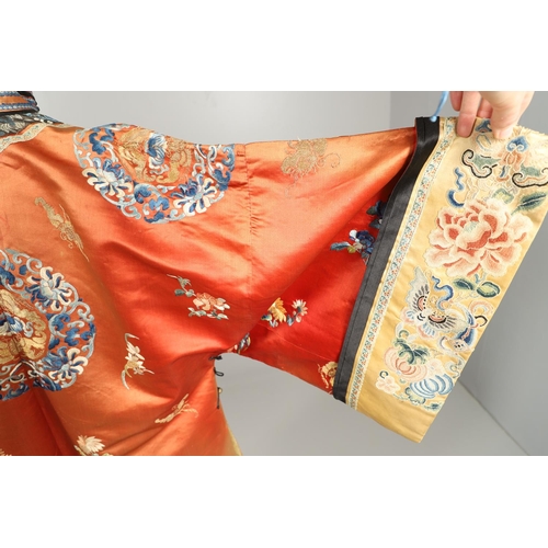 950 - EARLY 20TH CENTURY CHINESE EMBROIDERED SILK ROBE. A 3/4 length red silk robe heavily embroidered wit... 