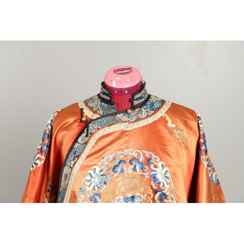 950 - EARLY 20TH CENTURY CHINESE EMBROIDERED SILK ROBE. A 3/4 length red silk robe heavily embroidered wit... 