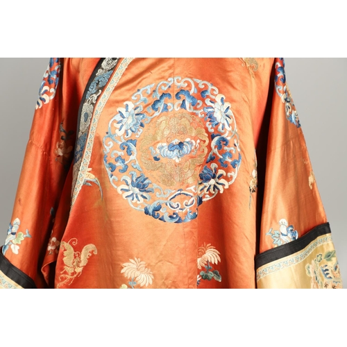 950 - EARLY 20TH CENTURY CHINESE EMBROIDERED SILK ROBE. A 3/4 length red silk robe heavily embroidered wit... 