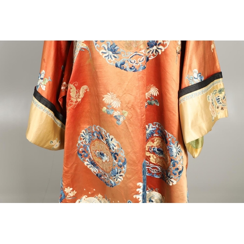 950 - EARLY 20TH CENTURY CHINESE EMBROIDERED SILK ROBE. A 3/4 length red silk robe heavily embroidered wit... 