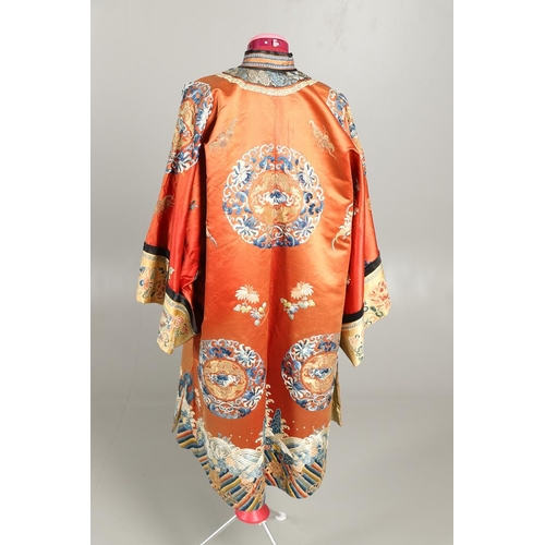 950 - EARLY 20TH CENTURY CHINESE EMBROIDERED SILK ROBE. A 3/4 length red silk robe heavily embroidered wit... 