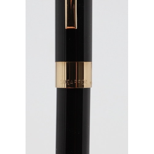 1533 - A SHEAFFER LEGACY FOUNTAIN PEN. the black case with gold plated trim and white dot to cap, 18k nib; ... 